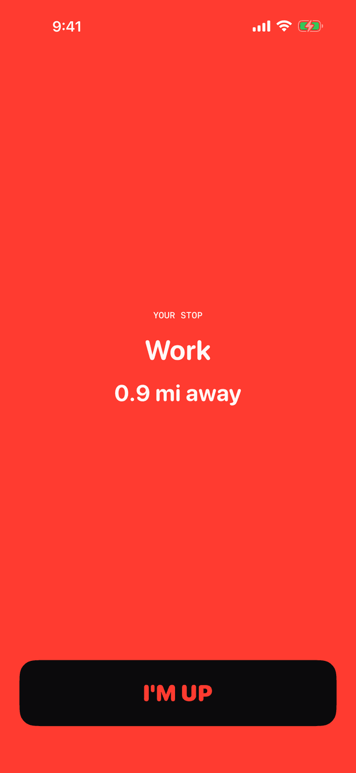 The Stopzone wake screen, the whole display turned red, naming the stop Work at 0.9 miles away, with a single I'm up button
